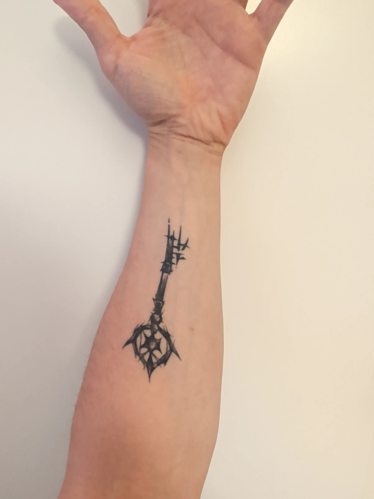 Lettering placed on a forearm photo. Drag it with the pointer, or use the arrow keys to move it. This is a preview — the full generator with your own text is further down the page.